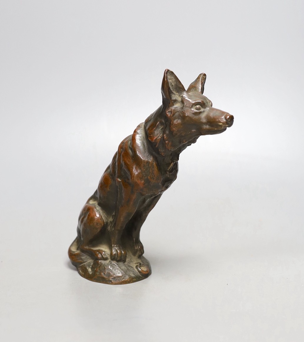 E, Ilinsky, a brown patinated bronze seated dog car mascot signed, worth foundry mark Fumiere et Cie, 16cm high